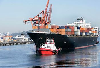 Cargo ship in calm water, Jones Act